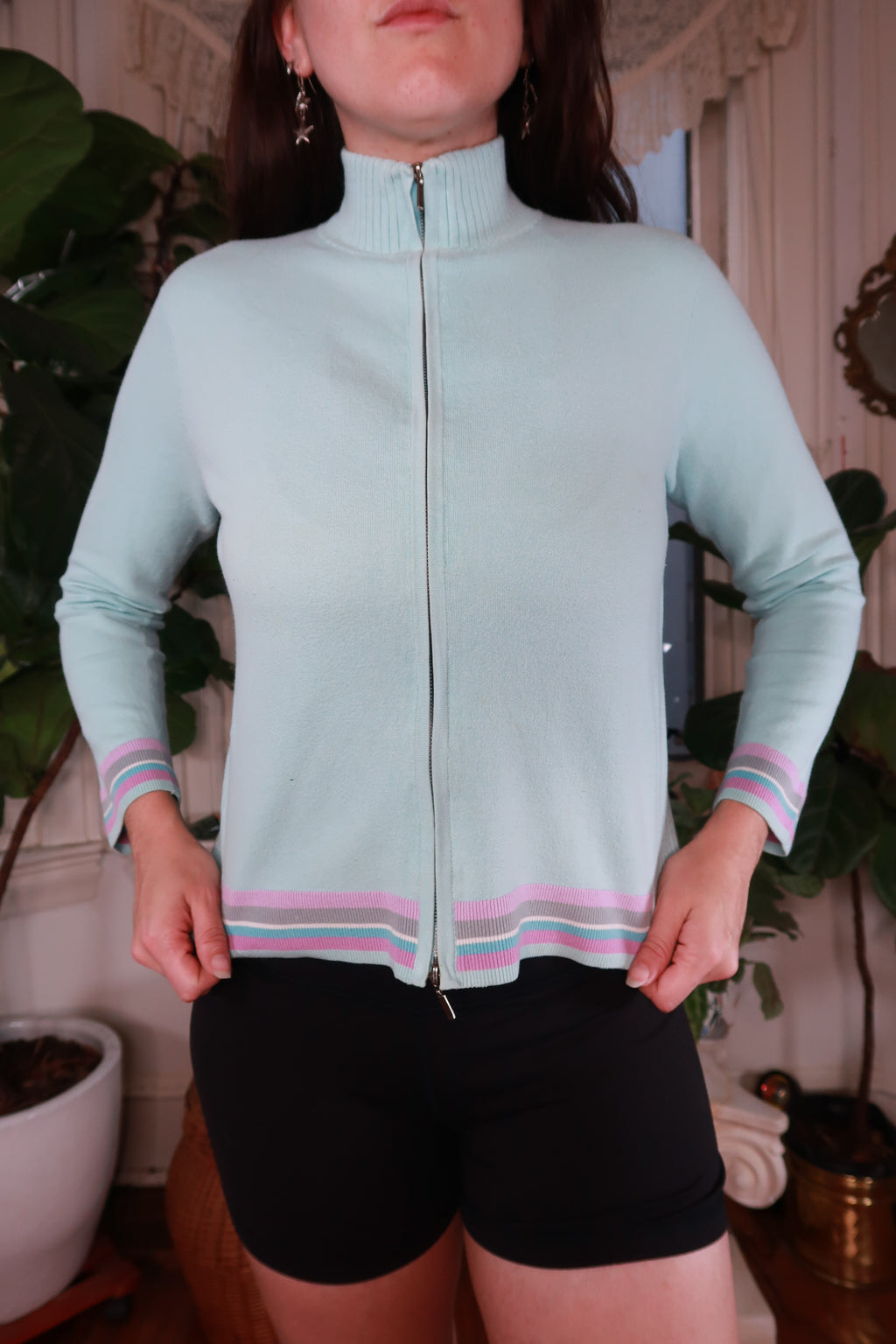 Women's vintage Y2K pastel blue striped zip-up sweater by Elektra Vintage, showcasing a cozy, retro-inspired top with pastel colors.