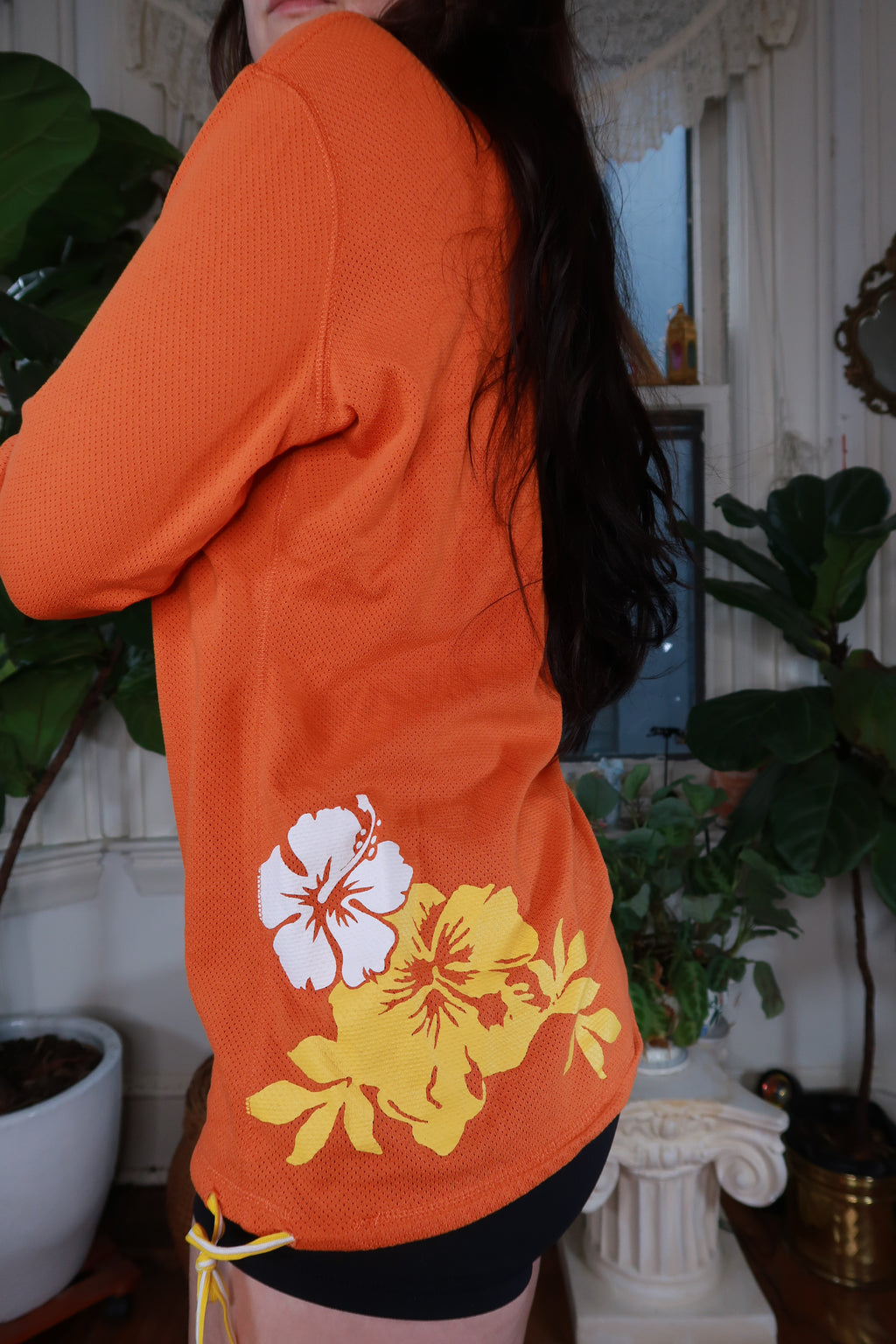 Vintage Y2K Nike orange mesh floral hoodie for women by Elektra Vintage, featuring a colorful floral design and mesh fabric.