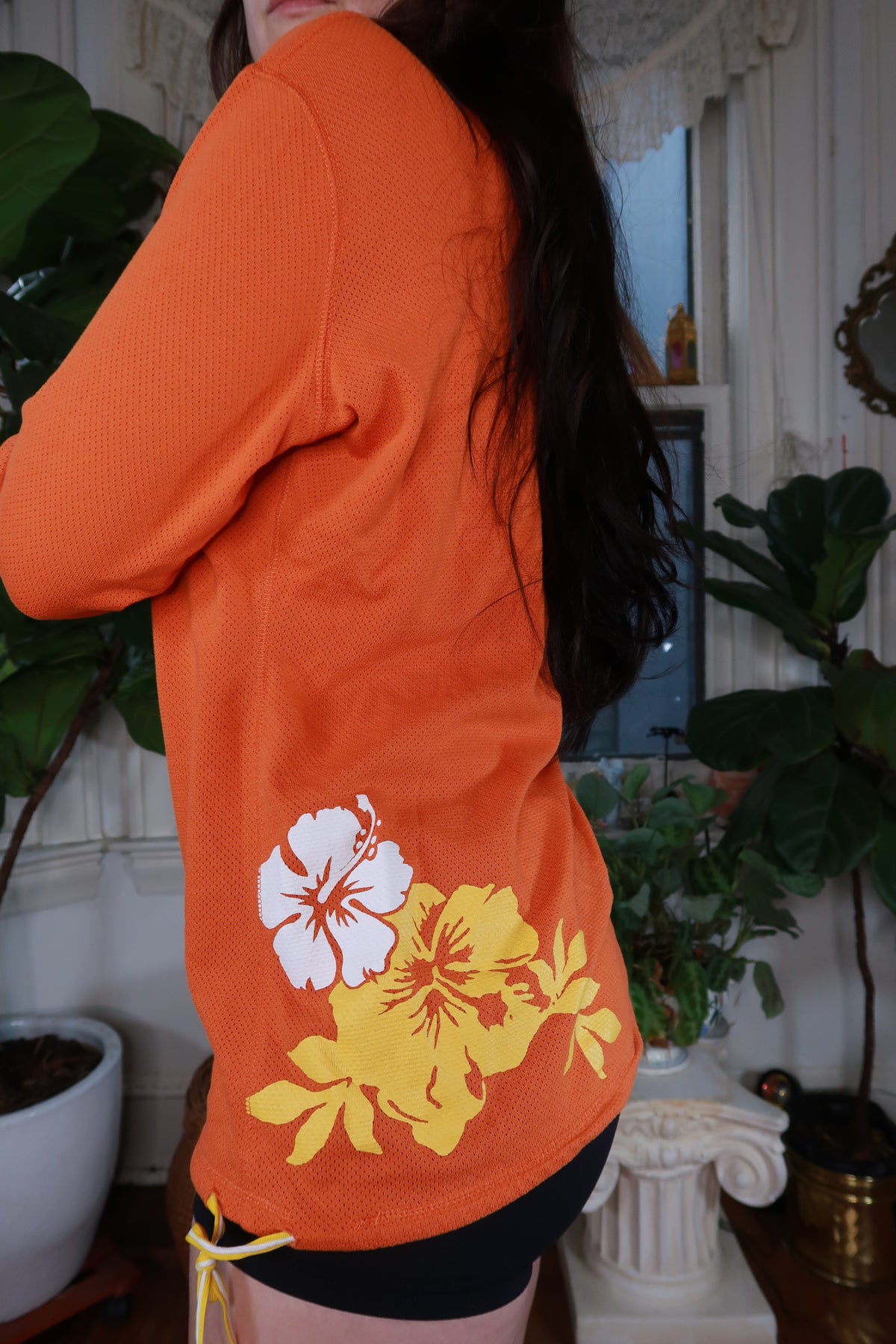 Vintage Y2K Nike orange mesh floral hoodie for women by Elektra Vintage, featuring a colorful floral design and mesh fabric.