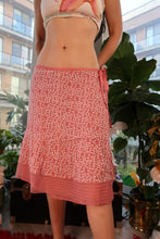Load image into Gallery viewer, Pink floral skirt from the 2000s vintage collection by Elektra Vintage, featuring a flowy fabric and retro style.
