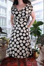 Load image into Gallery viewer, Vintage black and white polka dot wrap dress from Elektra Vintage featuring a Y2K fit and flare midi silhouette.
