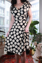 Load image into Gallery viewer, Vintage black and white polka dot wrap dress by Elektra Vintage featuring a Y2K fit and flare midi style.
