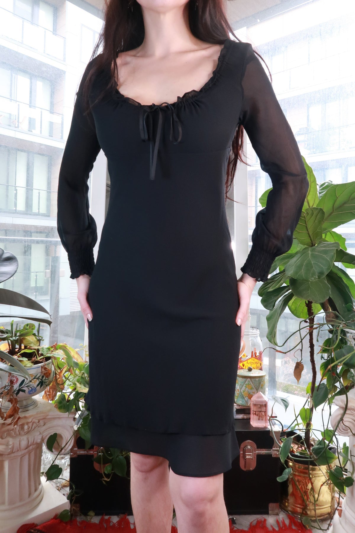 Black sheer silk dress by Elektra Vintage featuring romantic ruffle neck tie and mini length, with elegant long sleeves.