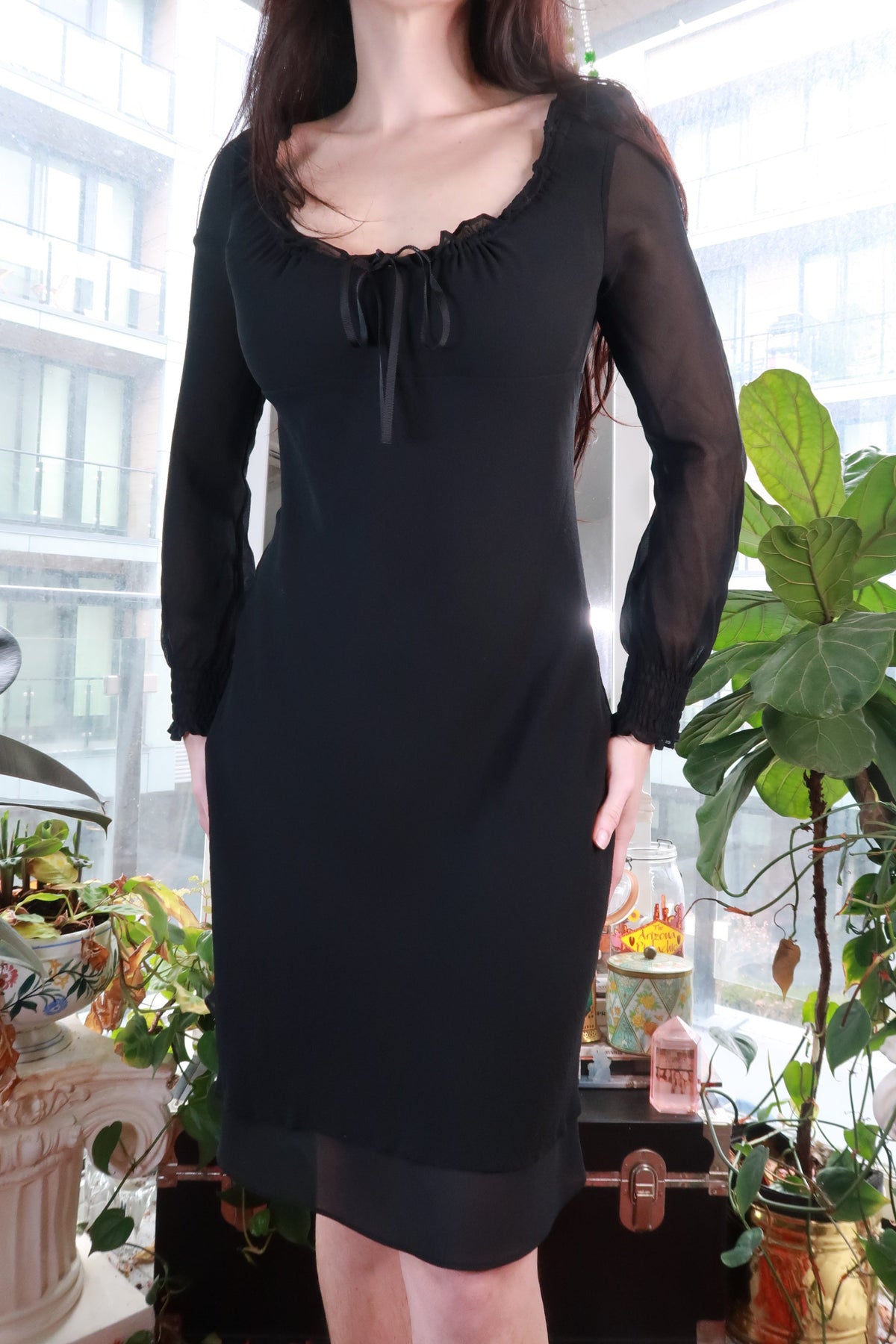Black silk dress by Elektra Vintage featuring sheer sleeves, romantic ruffle neckline, tie-front, mini length, vintage-inspired style.