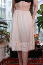 Load image into Gallery viewer, Vintage ivory satin half slip skirt with lace trim, classic midi underskirt by Elektra Vintage, shown with smooth fabric and delicate lace details.
