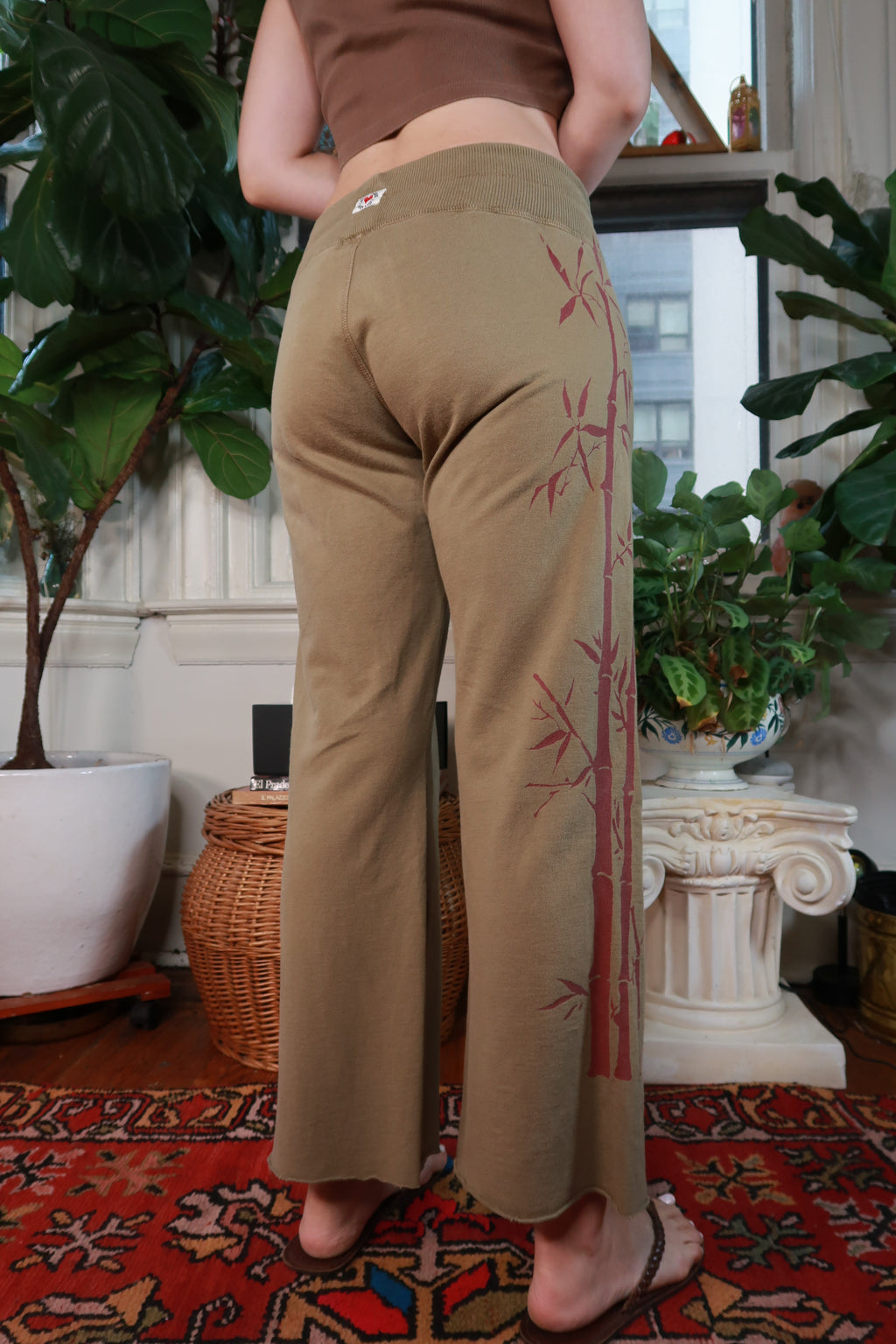 Women's vintage Lucky Brand olive green bamboo print pants, Y2K style, from Elektra Vintage, showing the relaxed fit and bamboo pattern.