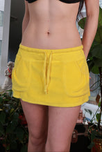 Load image into Gallery viewer, Yellow vintage 2000s Victoria’s Secret mini skirt by Elektra Vintage, low rise, terry fabric, Y2K lounge style, casual and retro look.
