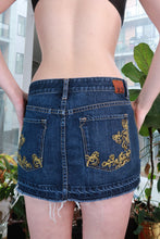 Load image into Gallery viewer, Dark wash denim micro mini skirt by Elektra Vintage featuring Y2K low rise fit and embroidered details, vintage 2000s style.
