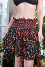Load image into Gallery viewer, Vintage 2000s Anna Sui floral silk mini skirt with smocked waist and boho garden print, by Elektra Vintage.
