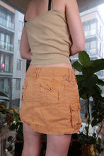 Load image into Gallery viewer, Orange vintage 2000s cargo mini skirt with bird graphic, low rise Y2K style, utility pockets, by Elektra Vintage.

