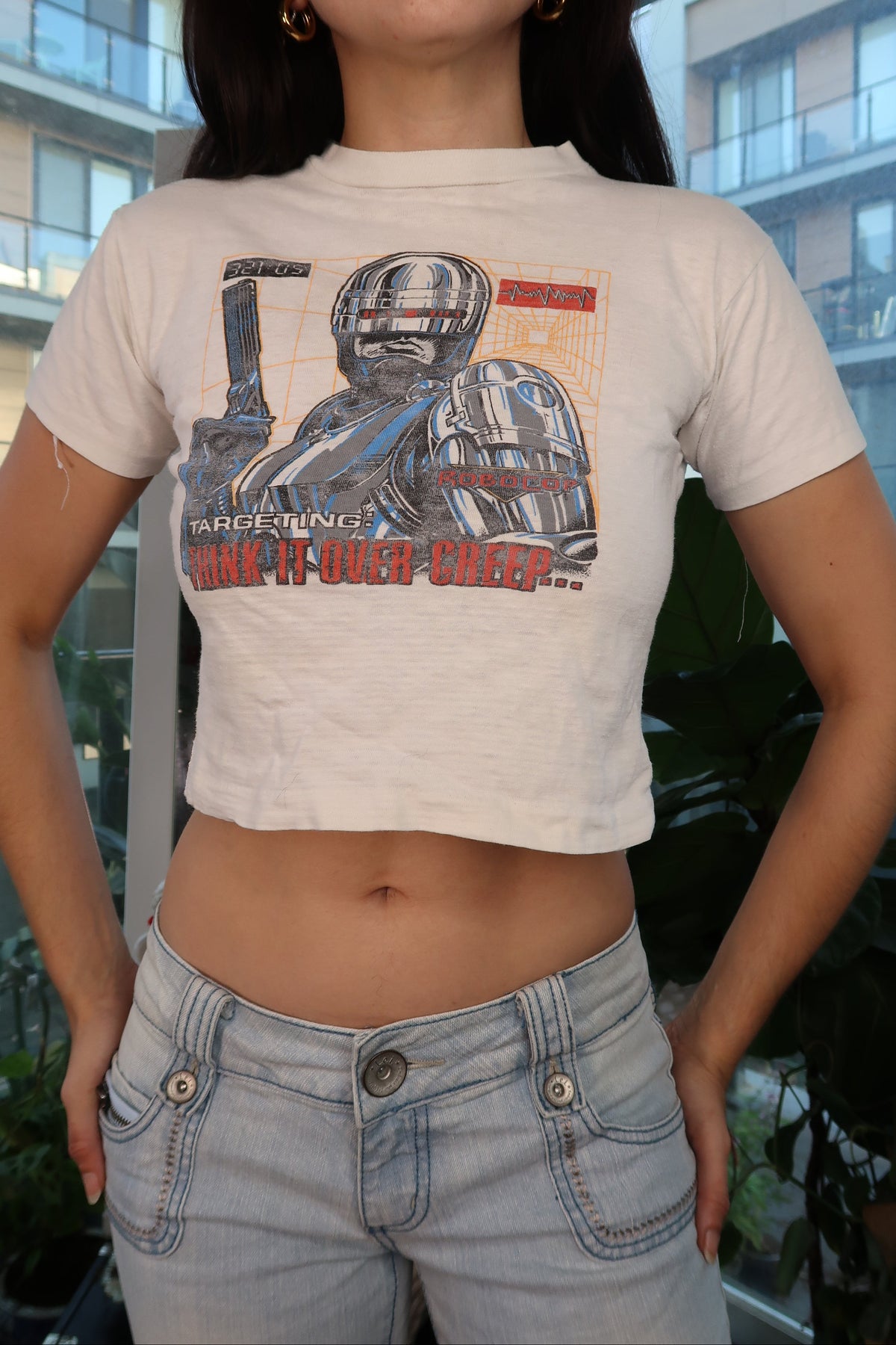 Vintage 90s RoboCop graphic baby tee for women by Elektra Vintage, featuring a retro RoboCop design on a casual top.