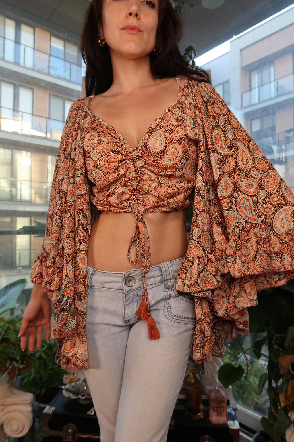 Vintage Y2K Elektra Vintage boho paisley bell sleeve crop top featuring a tassel tie detail.