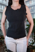 Black ribbed sleeveless tank top with raw edges, vintage 2000s style, by Elektra Vintage, shown on a woman.