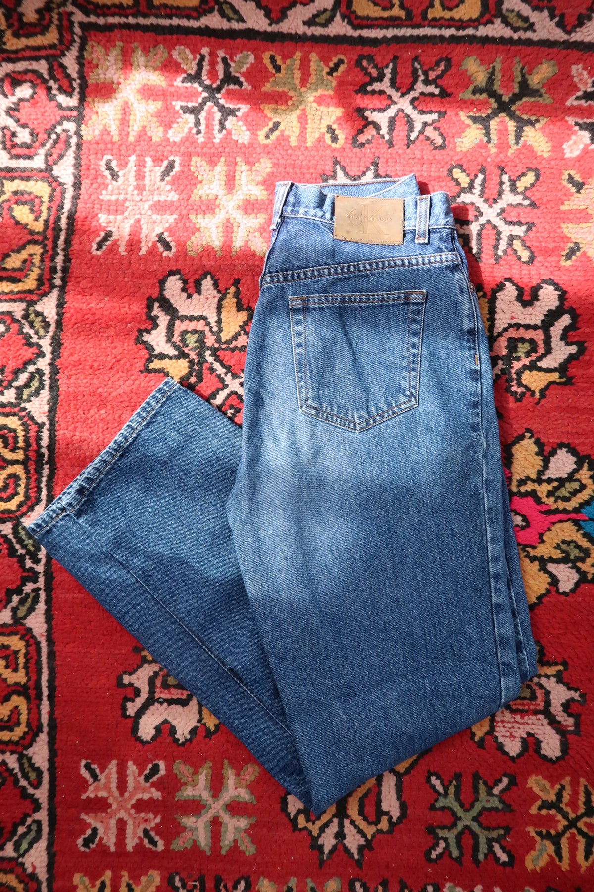 Men's vintage Calvin Klein classic straight leg jeans from Elektra Vintage, shown in a well-worn denim style with visible stitching.