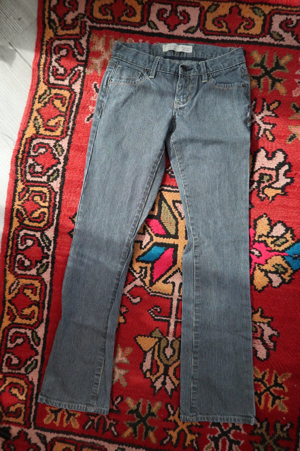 Vintage 2000s Old Navy pinstripe low-rise women's jeans with classic fit and light wash, displayed on a neutral background.
