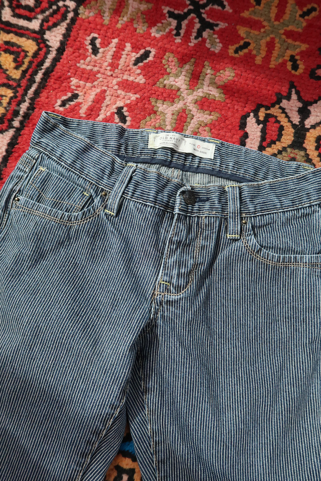 Elektra Vintage women's low-rise pinstripe jeans from the 2000s, vintage style with classic fit and denim texture.