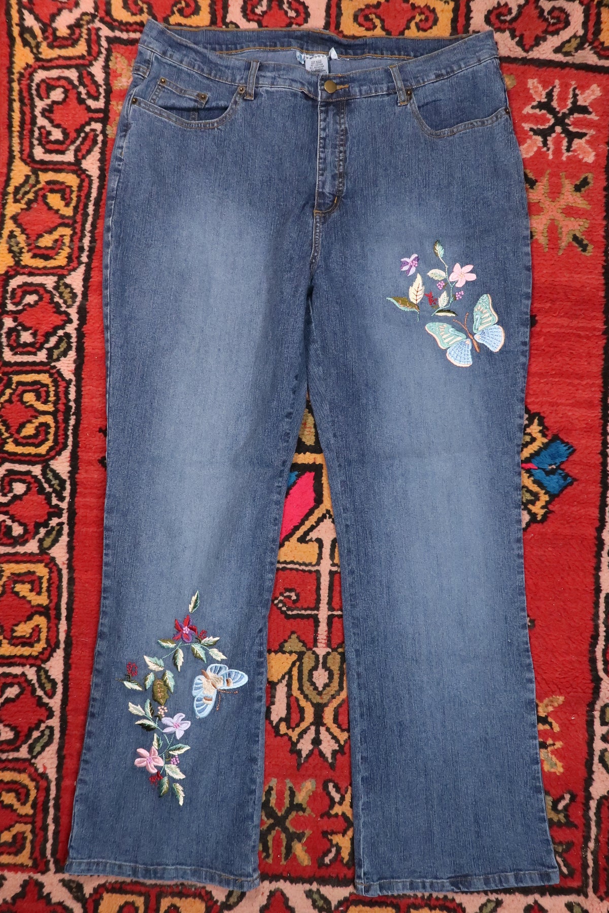 Women's vintage 2000s butterfly embroidered denim jeans by Elektra Vintage, featuring colorful butterfly embroidery on classic denim.