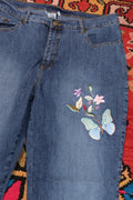 Vintage 2000s Butterfly embroidered denim jeans for women by Elektra Vintage, featuring colorful butterfly embroidery on classic blue denim.