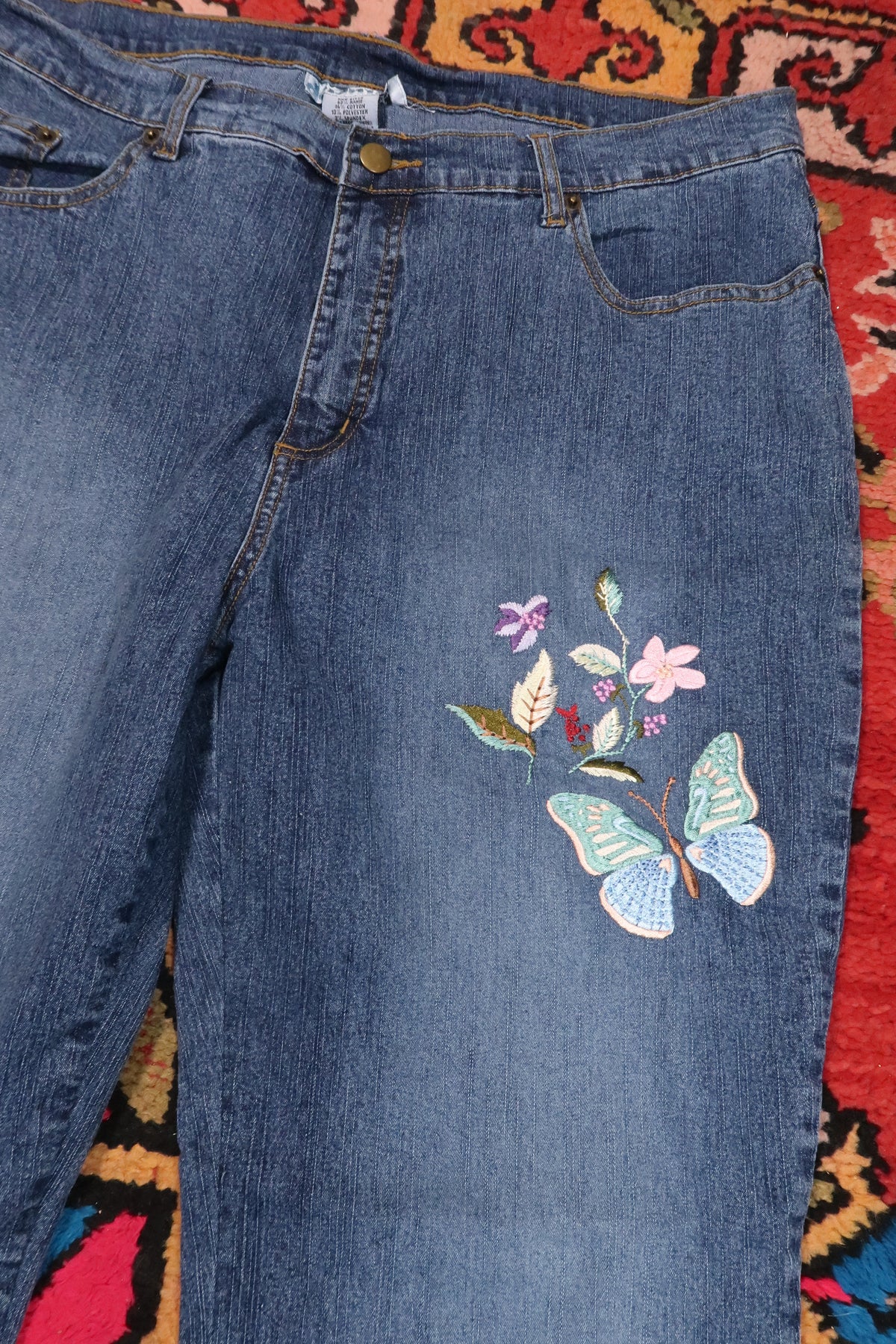 Vintage 2000s Butterfly embroidered denim jeans for women by Elektra Vintage, featuring colorful butterfly embroidery on classic blue denim.