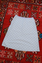 Load image into Gallery viewer, Vintage 2000s pastel blue plaid cotton midi skirt for women from Elektra Vintage, shown laid flat with pleats and waistband detail.
