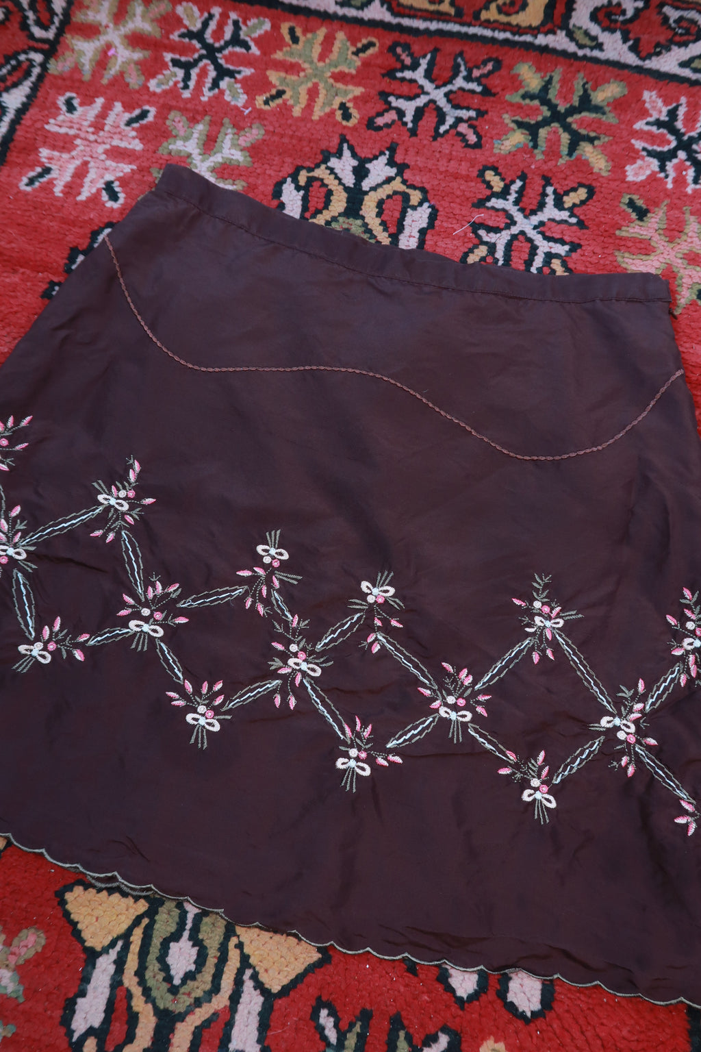 Chocolate brown silk embroidered mini skirt by Elektra Vintage, featuring intricate embroidery and a vintage style.