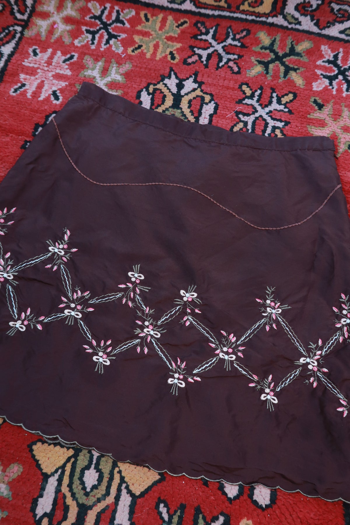 Chocolate brown silk embroidered mini skirt by Elektra Vintage, featuring intricate embroidery and a vintage style.