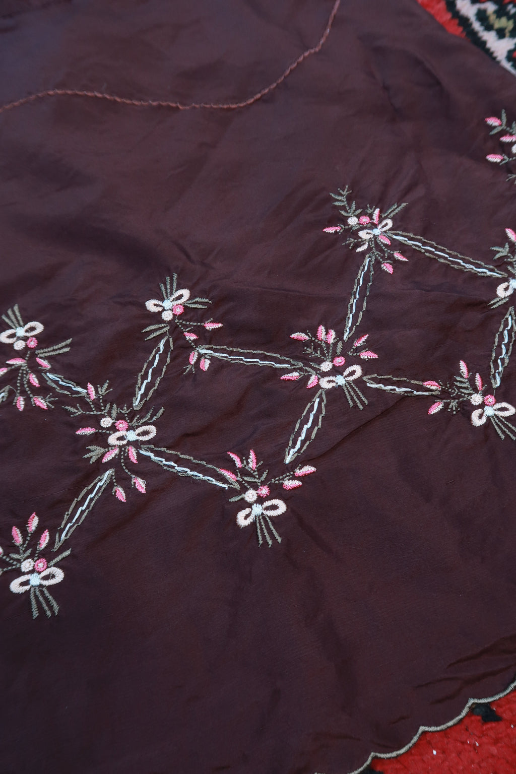 Chocolate brown silk embroidered mini skirt by Elektra Vintage, featuring intricate vintage embroidery and a fitted silhouette.