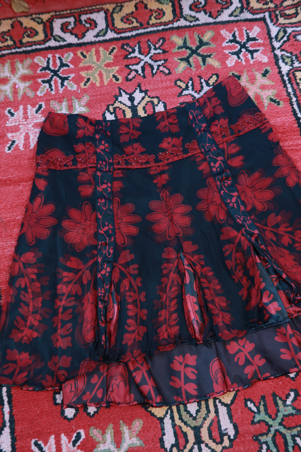 Black and red sheer silk floral ruffle mini skirt by Elektra Vintage, vintage 2000s fashion, with delicate ruffle details.