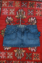 Load image into Gallery viewer, Vintage 2000s Mossimo low rise denim micro mini skirt, casual style, shown with a button and zipper closure, black denim fabric.
