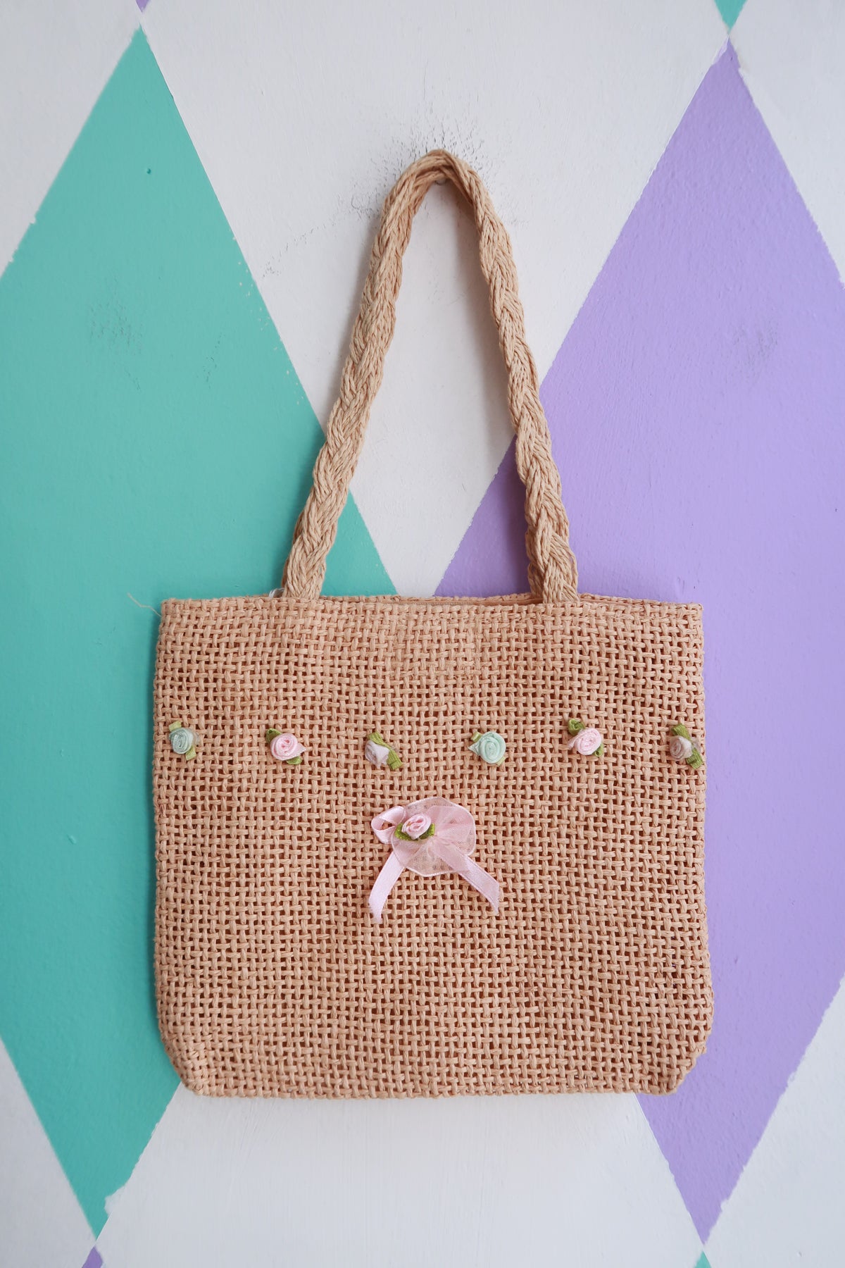 Vintage 2000s mini woven straw handbag with floral embellishments by Elektra Vintage, featuring a compact hand-held bag design.