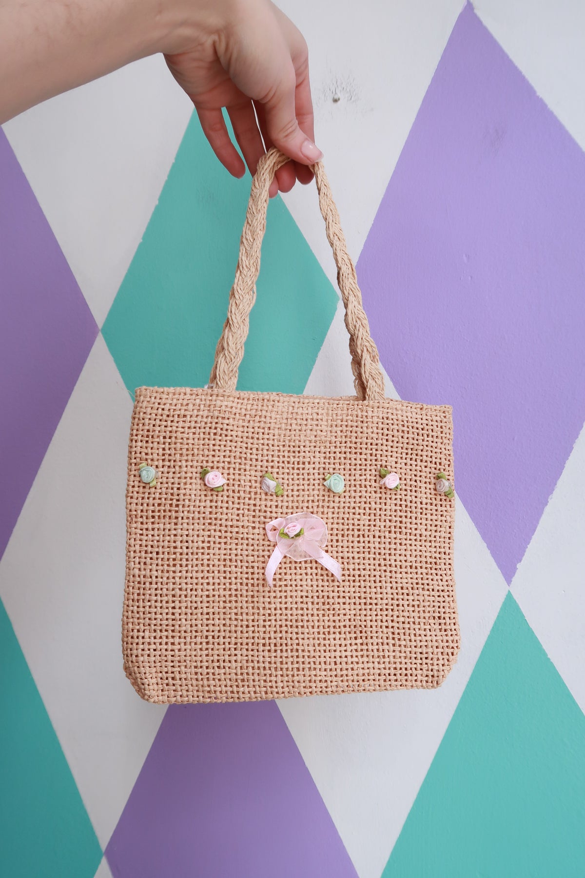 Vintage 2000s Elektra Vintage mini woven straw handbag with floral embellishments, showcasing a charming and detailed handbag design.