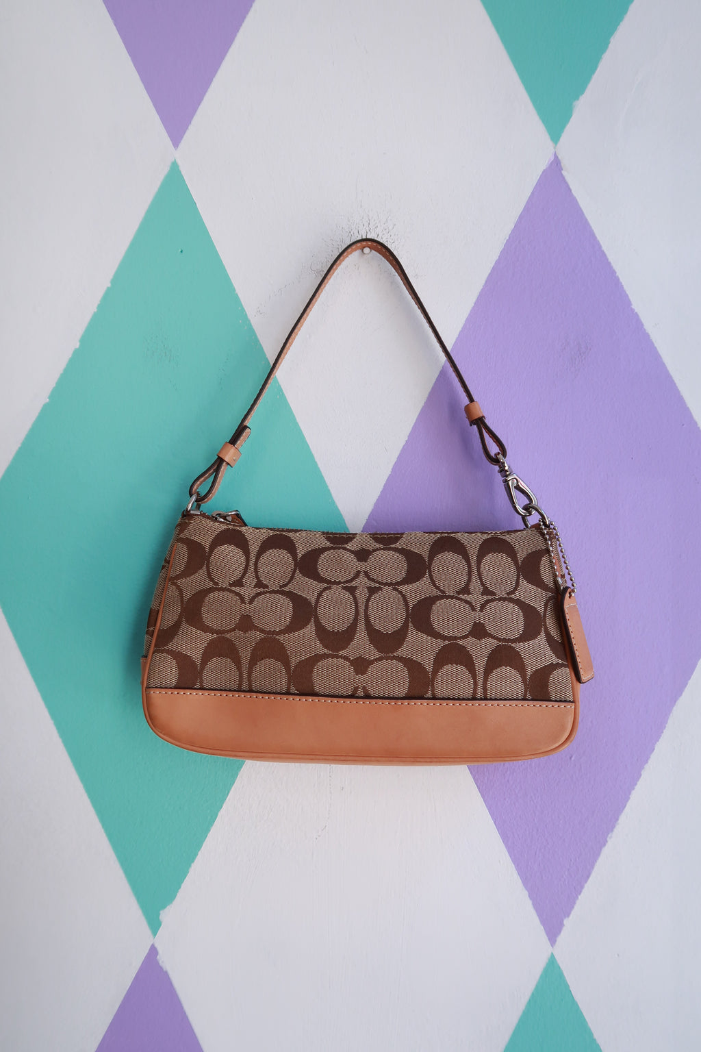 Vintage 2000s Coach Signature brown monogram canvas baguette shoulder bag with leather accents, casual and stylish accessory.