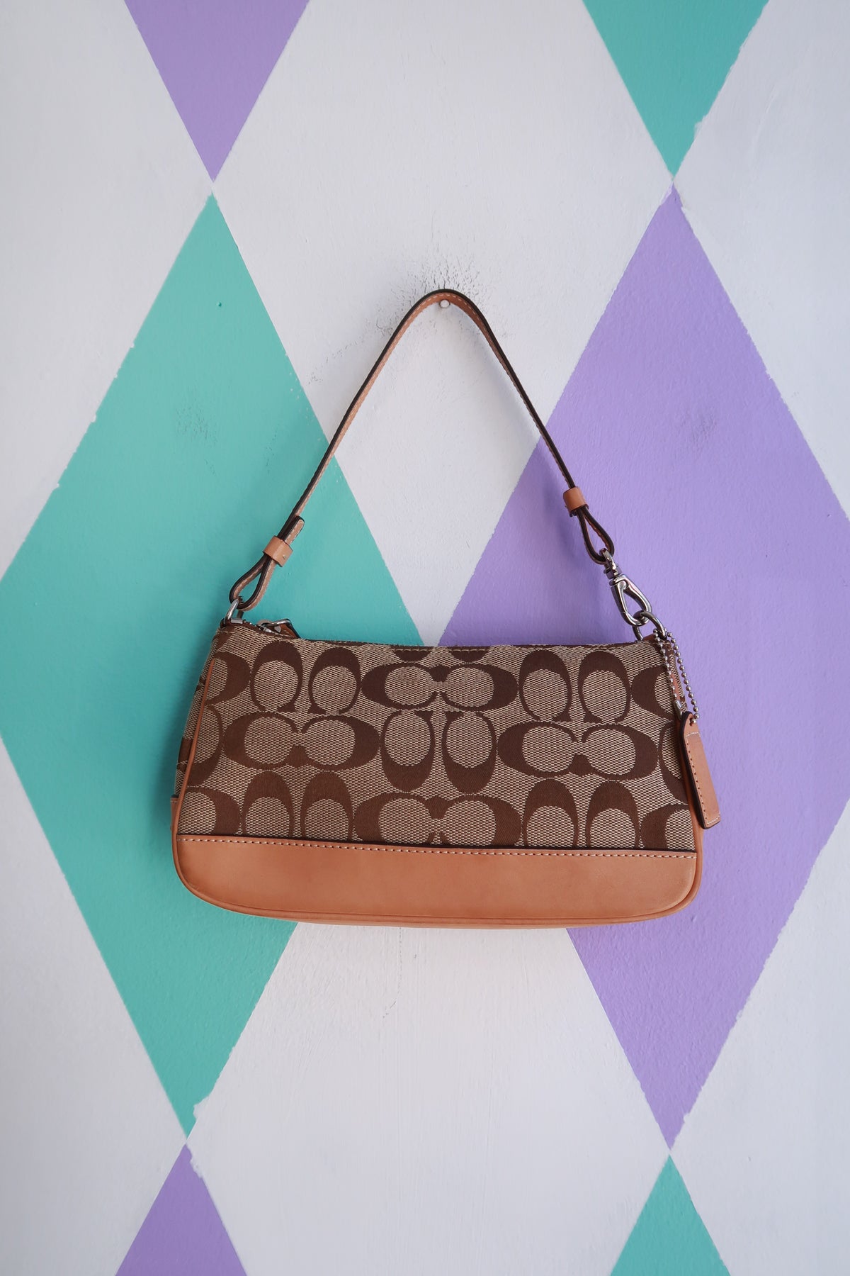 Vintage 2000s Coach Signature brown monogram canvas baguette shoulder bag with leather accents, casual and stylish accessory.