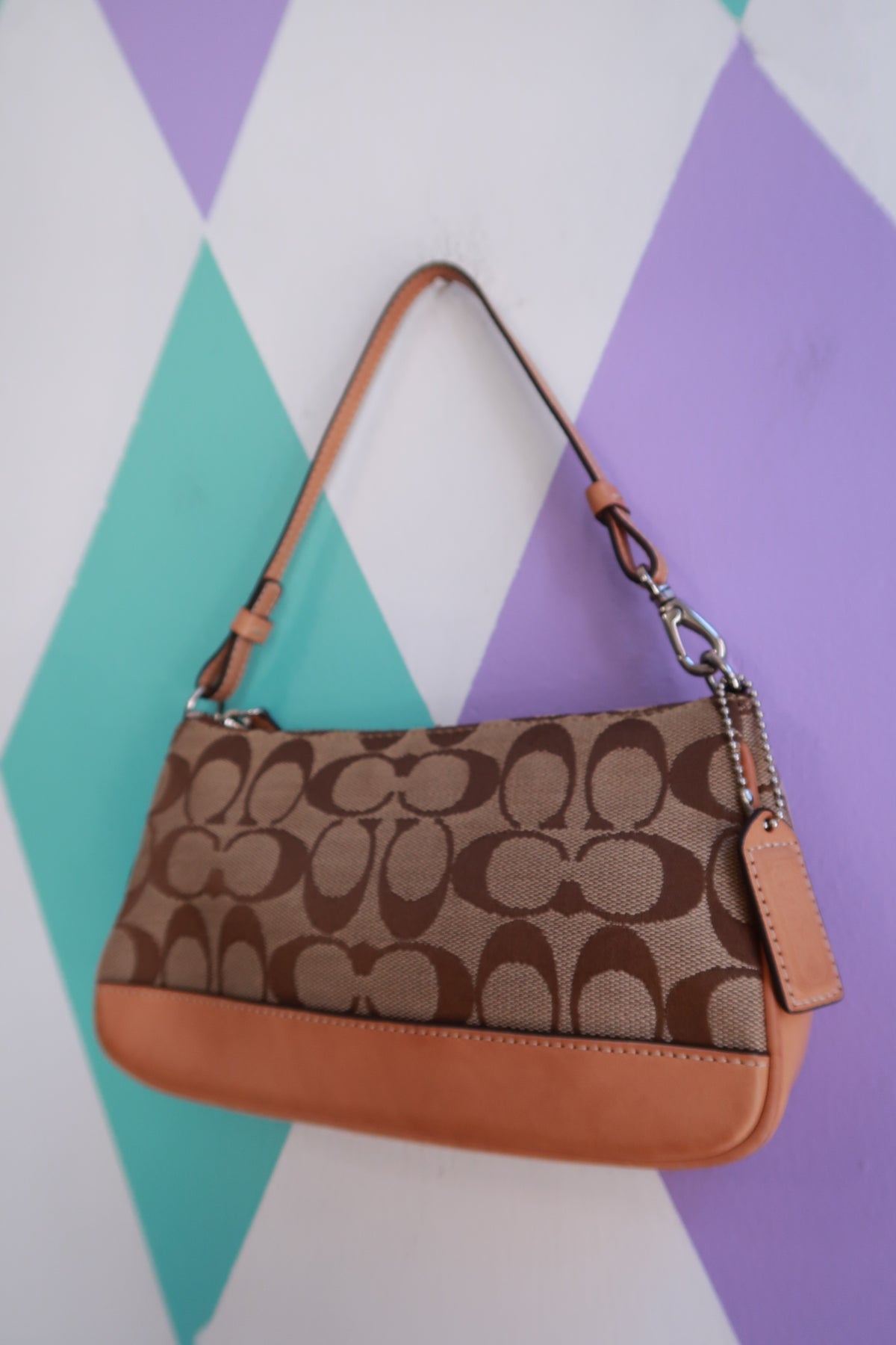 Vintage 2000s Coach Signature brown monogram canvas baguette shoulder bag with leather accents, styled for a classic look.