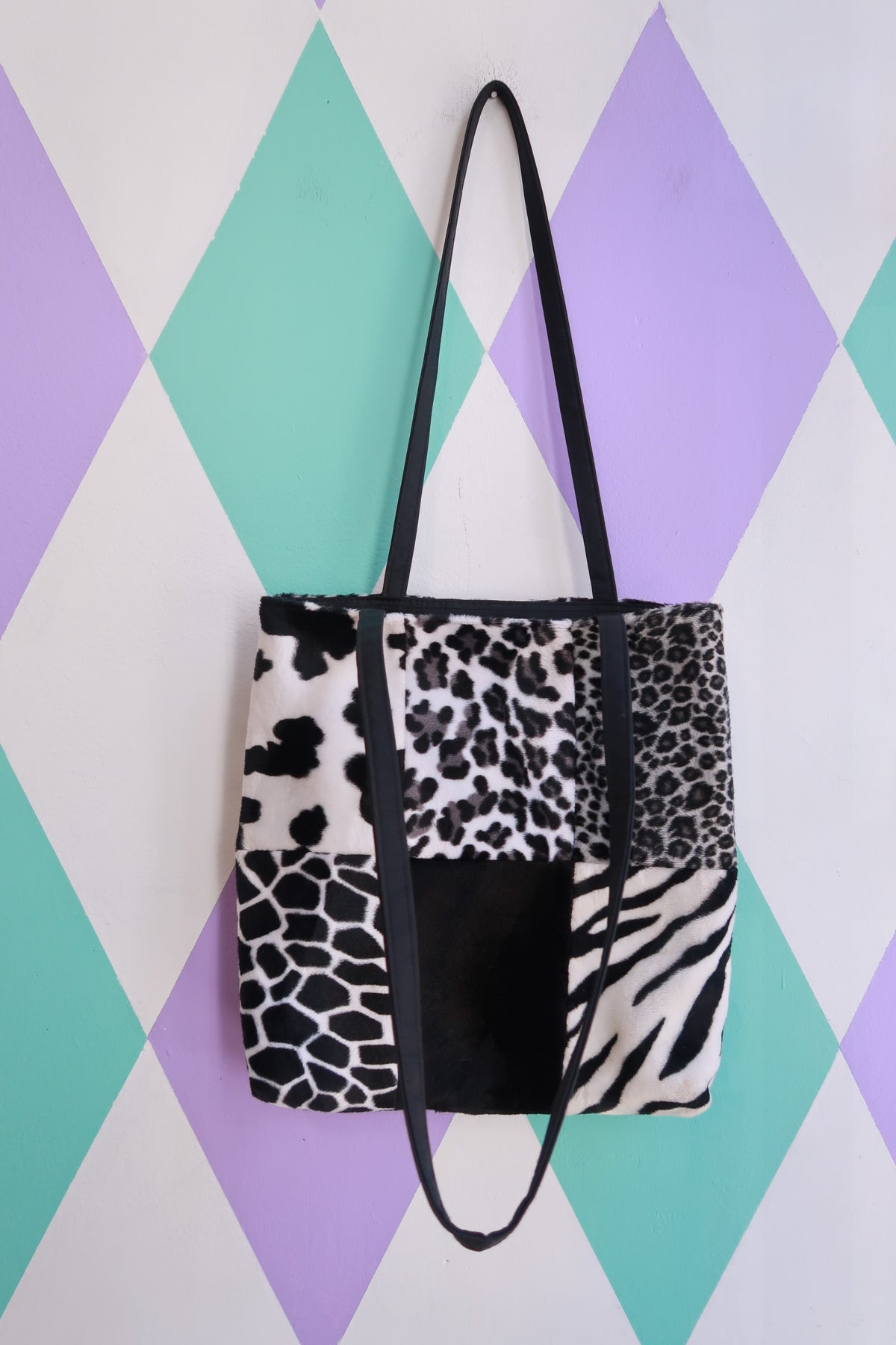 Vintage 2000s black and white animal print patchwork faux fur tote bag by Elektra Vintage, showing detailed fabric and design.