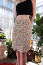 Load image into Gallery viewer, Vintage 2000s GAP 100% silk floral midi skirt with cream garden print, Y2K style, by Elektra Vintage, shown on a hanger.
