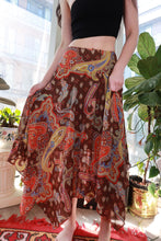 Load image into Gallery viewer, Vintage 2000s paisley midi skirt by Elektra Vintage, brown and red boho Y2K handkerchief hem skirt displayed on model.
