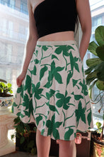 Load image into Gallery viewer, Vintage 2000s green floral A-line mini skirt from Elektra Vintage featuring white and emerald green colors.
