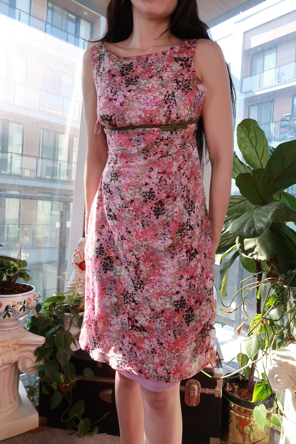 Vintage pink abstract floral sheath dress by Elektra Vintage with waist belt detail, close-up of the elegant, fitted dress design.