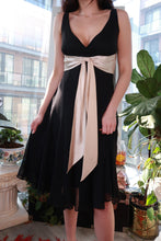 Load image into Gallery viewer, Vintage 2000s black chiffon midi dress with champagne satin waist tie, by Elektra Vintage, featuring elegant flowing fabric and a fitted waist.
