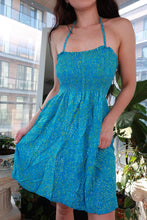 Load image into Gallery viewer, Vintage 2000s turquoise blue smocked halter dress with Y2K leaf print and babydoll mini style from Elektra Vintage.
