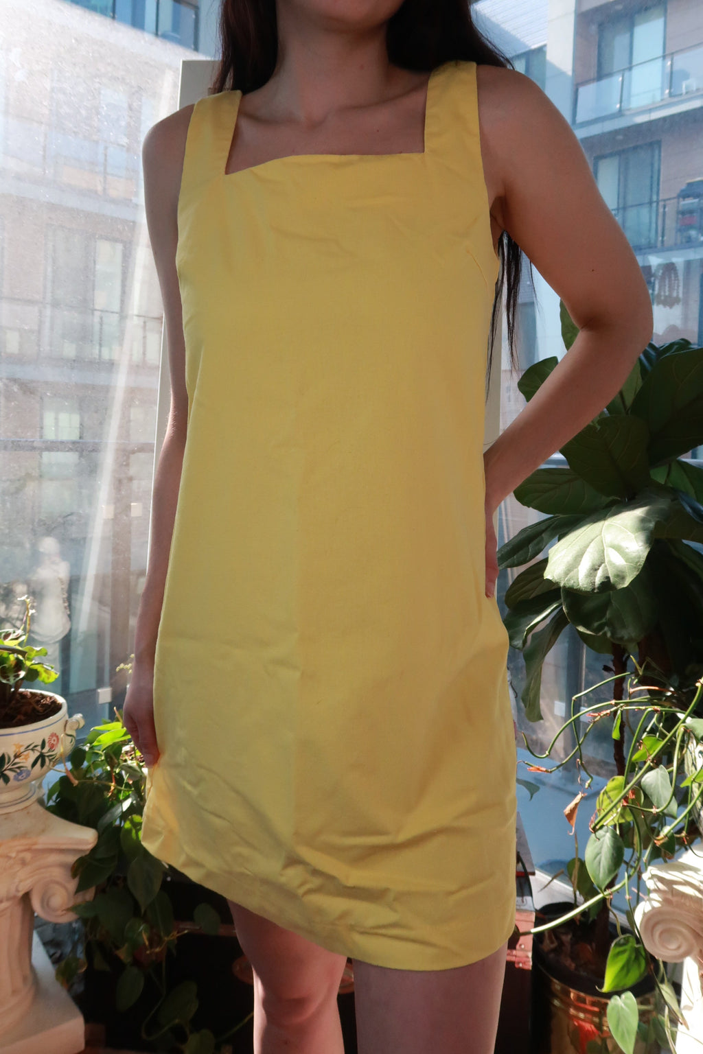 Vintage pastel yellow Elektra Vintage mini dress with square neckline, sleeveless, minimal shift style inspired by 90s Y2K fashion.