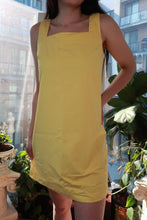 Load image into Gallery viewer, Vintage pastel yellow Elektra Vintage mini dress with square neckline, sleeveless, minimal shift style inspired by 90s Y2K fashion.
