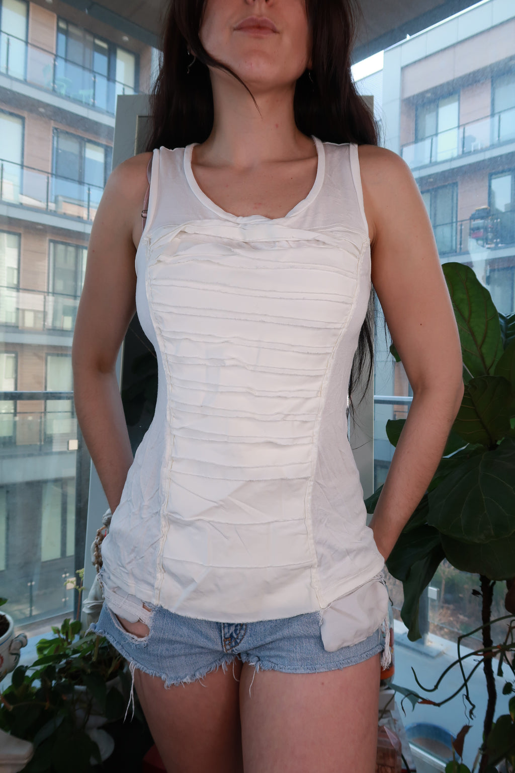 Women's white vintage BCBG tank top with Y2K panel design, fitted style from Elektra Vintage, shown on a hanger.