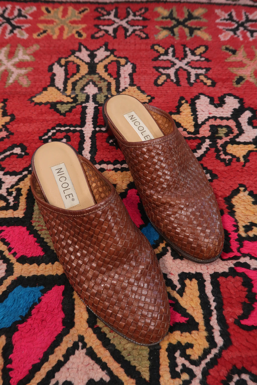 Vintage Nicole woven leather mules by Elektra Vintage, showcasing classic design and craftsmanship on a neutral background.