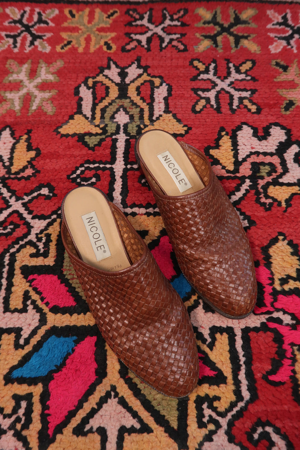Vintage Nicole woven leather mules by Elektra Vintage, showcasing classic design and textured leather on a neutral background.