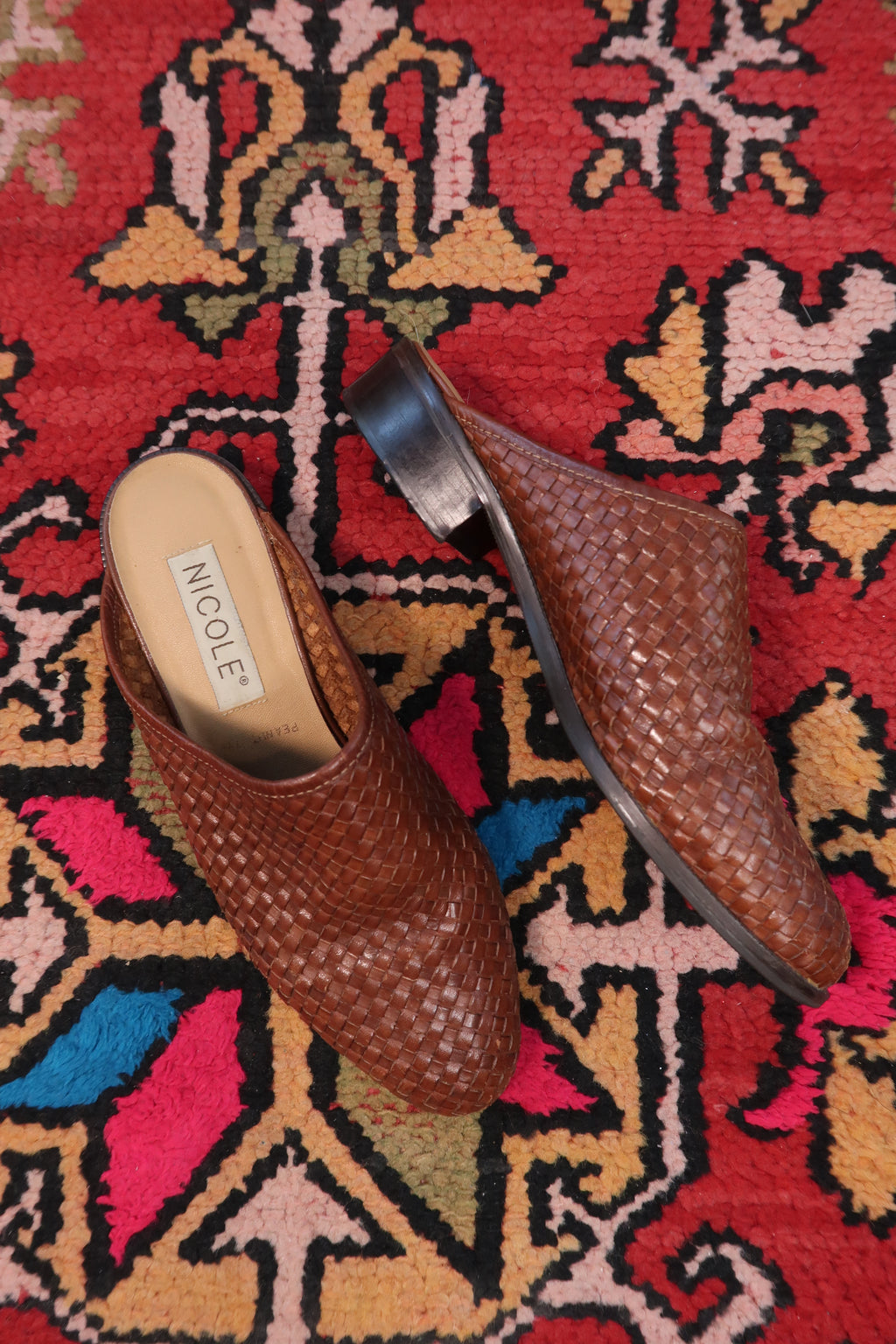 Vintage Nicole woven leather mules by Elektra Vintage, featuring a classic design with braided leather straps and a comfortable flat sole.