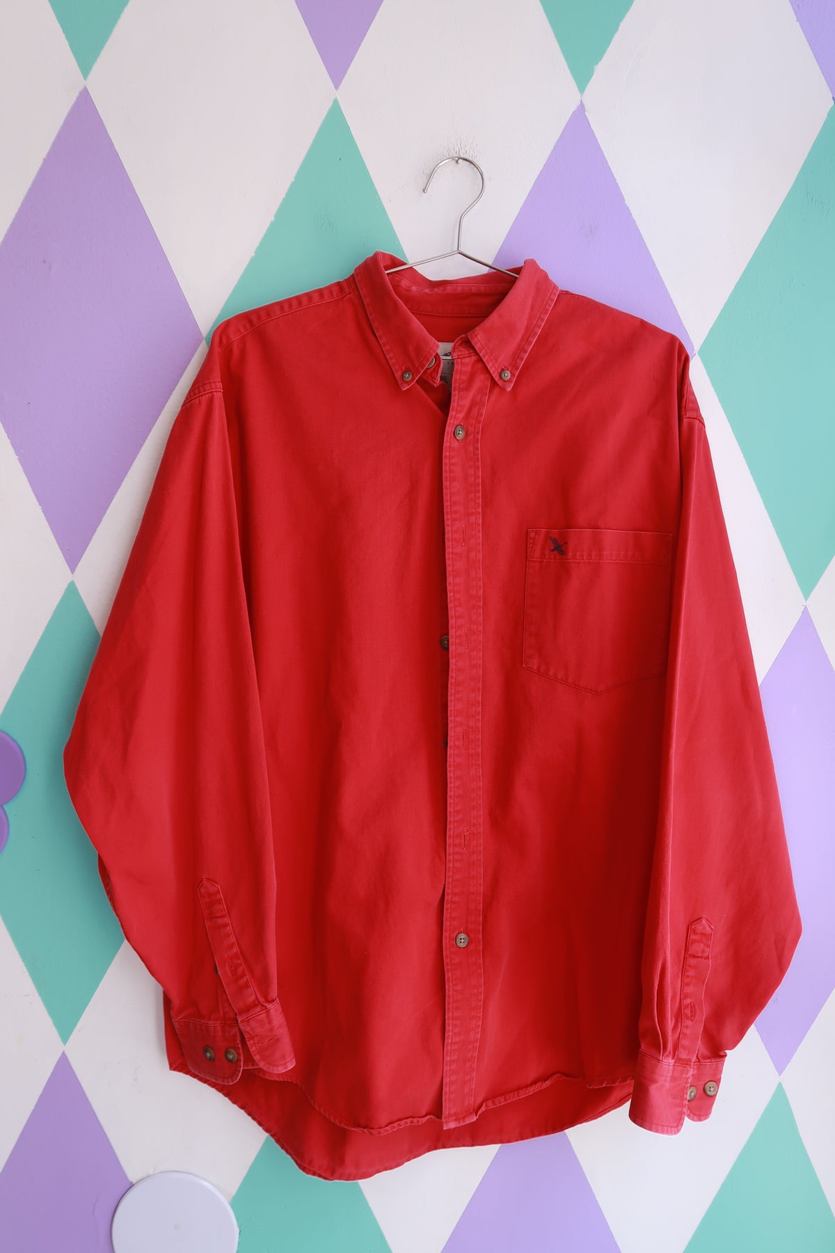 Men's vintage Eddie Bauer red button-down shirt with classic cotton fabric and oversized fit, styled by Elektra Vintage.