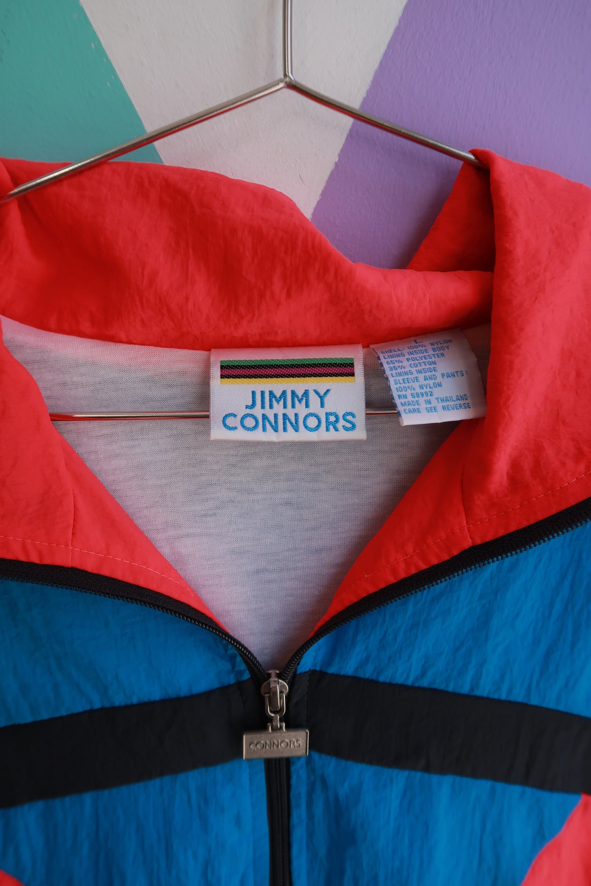 Vintage 90s Jimmy Connors colorblock windbreaker jacket for men, teal, pink, and black zip-up top by Elektra Vintage.