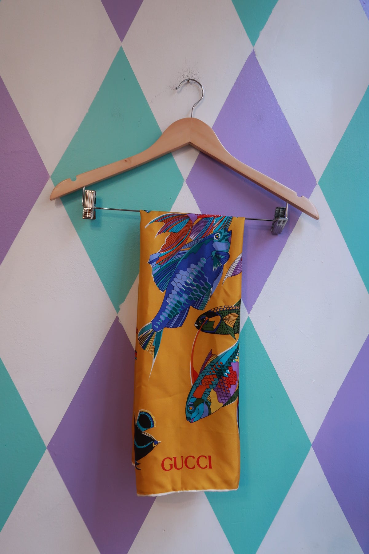 Vintage Gucci silk tropical fish scarf in golden yellow with multicolor fish design, elegant designer silk accessory.